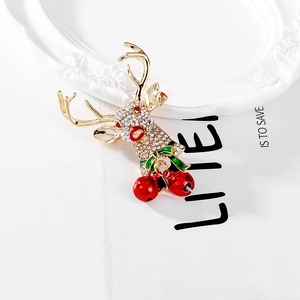 Vintage Christmas reindeer brooch with crystal antlers, green bow, and red jingling bells