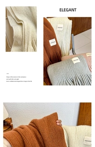 Close-up of elegant knitted scarf texture with tassels and hand-made label details