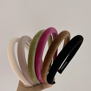 Macro shot of handmade thick velvet headbands in various colors with a soft matte finish