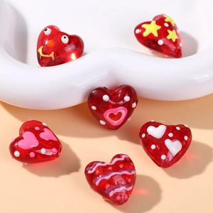 Red heart-shaped glass beads with colorful hand-painted patterns for DIY jewelry making