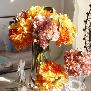 Vibrant orange and pink artificial hydrangea bouquet in clear glass vase for home decor