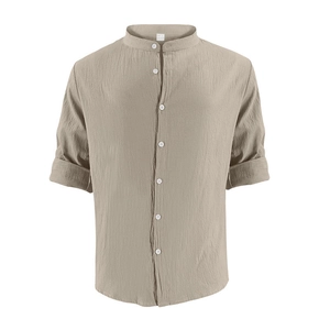 Detailed macro view of the stand-up collar and button placket on khaki linen shirt