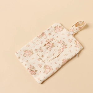 Close-up of floral cotton baby wipe storage bag with zipper and snap-button handle