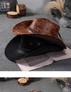Close-up of vintage Western cowboy hats in brown faux leather and matte black straw
