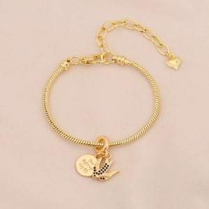 Detail of gold snake chain bracelet with swallow charm and 'You light up my life' engraving