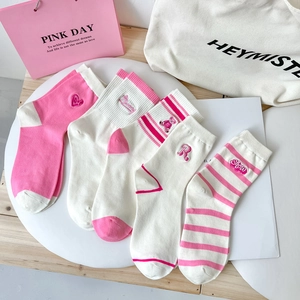 Flat lay of pink and white cotton crew socks with cute bear and rabbit embroidery