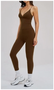 Detail of high-waist yoga leggings and thin strap sports bra in dark brown coffee color