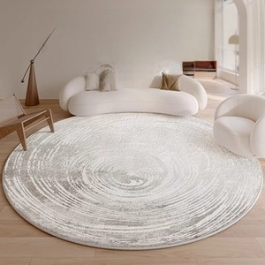 Detailed view of large round rug with grey spiral wave pattern in modern living room setting