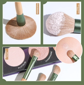 Macro detail of high-quality wood makeup brushes showing dense bristles and powder pickup