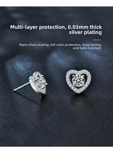 Macro shot of silver heart stud earrings with sparkling moissanite stones and thick plating