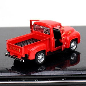 Rear view of red vintage alloy pickup model with functional tailgate and doors