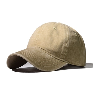 Detail view of khaki washed cotton baseball cap showing vintage texture and stitching