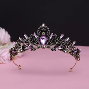 Macro view of vintage baroque crown featuring purple pear-shaped crystal and black diamonds