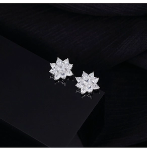 Macro detail of S925 silver flower stud earrings with sparkling cubic zirconia stones