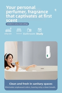 Wall-mounted white automatic aroma diffuser shown in a modern bathroom setting