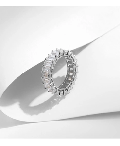 Macro shot of silver S925 eternity ring featuring rectangular-cut channel-set cubic zirconia