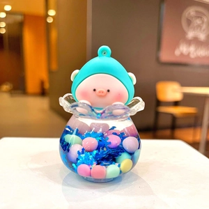 Close-up of a cute pig character figurine with blue headgear and colorful sequins jar