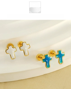 Detail of cross-shaped screw back earrings in gold finish with blue and white enamel fill
