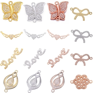 Macro detail of 16 zircon inlaid butterfly and flower connector charms for jewelry making