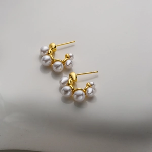 Elegant 18K gold plated C-shaped earrings with white pearls on a clean white background