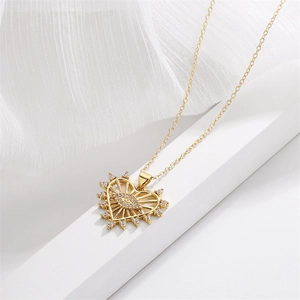 Detail of gold heart pendant with evil eye motif on white geometric stand