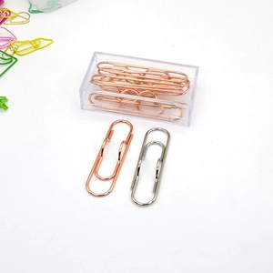 Macro view of heart-shaped rose gold and silver metal pen clips in a clear storage box