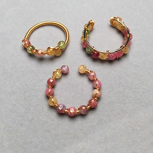 Detail of 14K gold filled wire wrapped rings with colorful tourmaline faceted beads