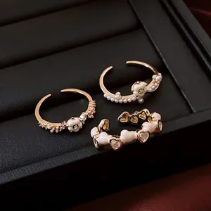 14K gold plated ring set featuring white flowers, pearls and hollow heart details