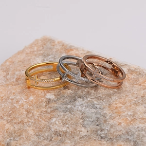 Three hollow cross rings in gold, silver, and rose gold finishes with micro-inlaid diamonds
