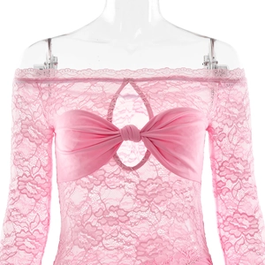 Detail view of pink lace off-shoulder top with large bow and cutout design on bust