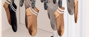 Detailed view of striped cotton socks hanging on a rack in soft natural light