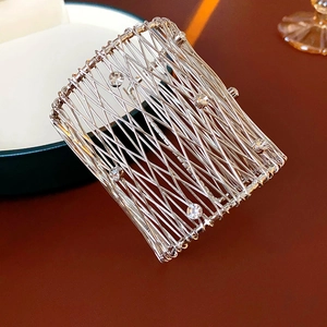 Macro shot of silver woven mesh cuff bracelet with sparkling crystal rhinestones