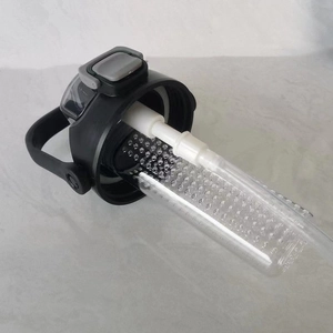 Detail view of the black sports water bottle lid with filter basket and white straw