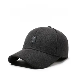 Detail of dark grey winter baseball cap with ear protection and side embroidery detail