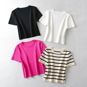 Flat lay macro of four slim-fit knit T-shirts in black, white, pink and striped colors