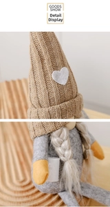 Detailed view of the knitted heart hat and plush texture on Christmas gnome decoration
