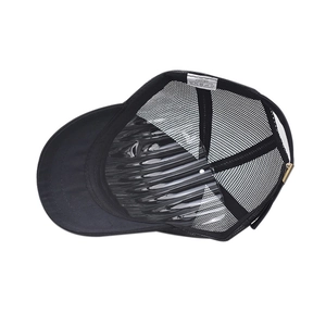 Detail view of black mesh trucker hat interior with breathable fabric and adjustable strap