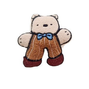 Cute beige teddy bear plush brooch with brown striped overalls and blue bow tie