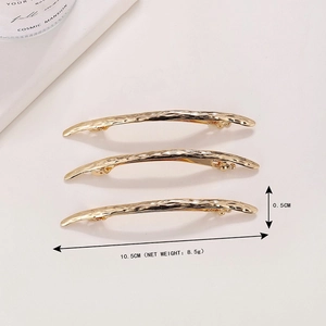 Three pieces of long arched gold metal hair clips with unique hammered texture surface