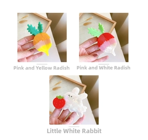 Detail shot of acetate hair claws featuring bunny and carrot shapes in pastel colors
