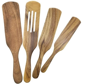 Top view of four teak wood kitchen utensils including slotted spatulas and scrapers on white background