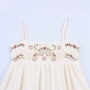 White embroidered summer dress with ethnic floral patterns and thin adjustable straps