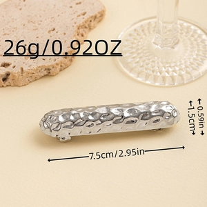 Detailed view of silver hammered metal hair clip showing 7.5cm length and 26g weight