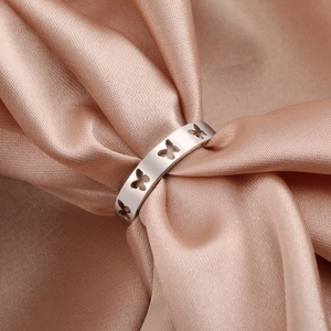Minimalist hollow butterfly stainless steel ring with polished silver finish on satin fabric