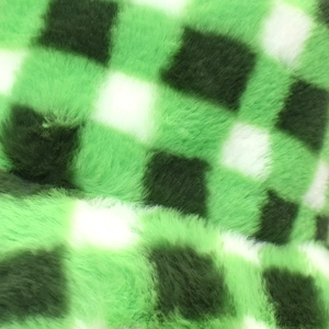 Macro shot of green and white checkerboard plush faux fur material on bucket hat