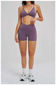 Detail view of purple yoga set with twisted sports bra and cross waist gym shorts