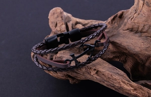 Detail of dark brown multilayer leather bracelet with black metal anchor and magnetic clasp