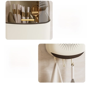 Detail of wall-mounted kitchen rack with gold handles, hooks, and dustproof lid