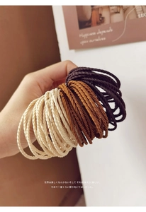 Detailed view of high-elasticity braided hair ties in cream, caramel, and coffee brown colors