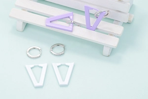 Irregular geometric trapezoid earrings set with white and purple enamel pendants